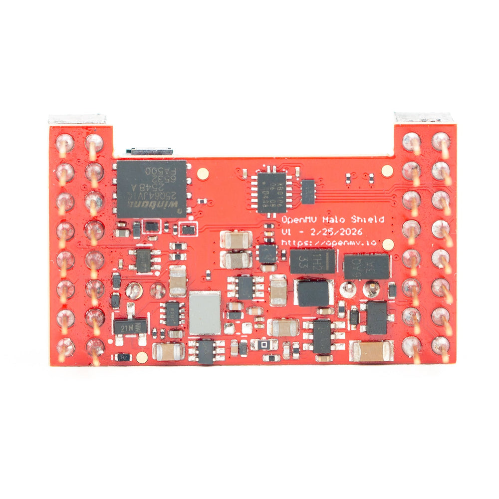 An orange-red electronic shield board with various integrated circuit chips, capacitors, and silver pin headers, on a plain white background.